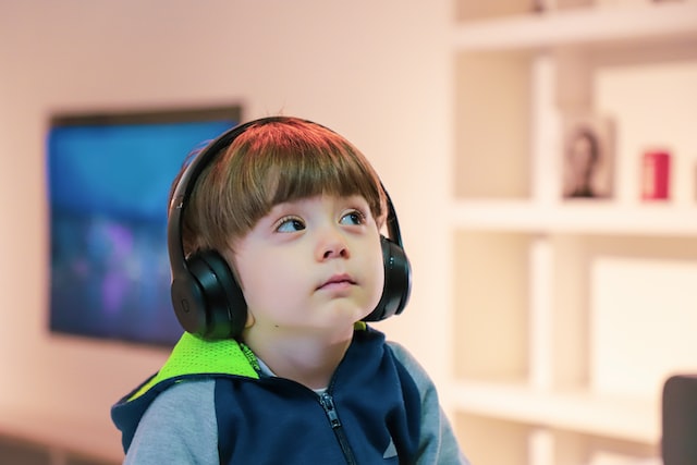 A child wearing headphones looking sad